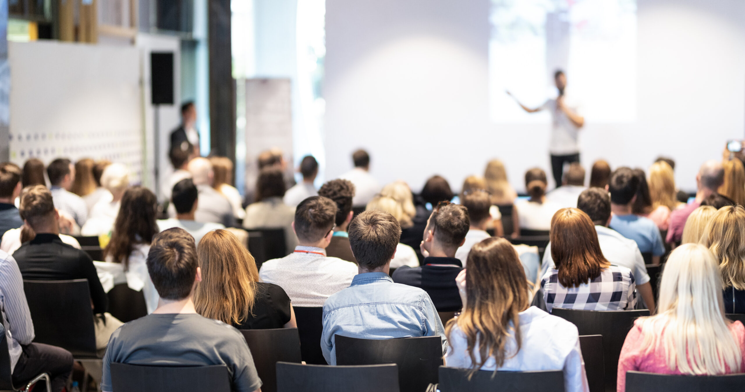 people in a room listening to a presentation